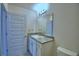 Bathroom featuring a granite vanity with updated fixtures and a framed mirror at 1476 Leamington Lane, Winter Haven, FL 33884