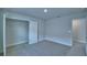 Inviting bedroom features plush carpeting and ample closet space for storage and organization at 1476 Leamington Lane, Winter Haven, FL 33884