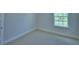 Neutral bedroom featuring a window at 1476 Leamington Lane, Winter Haven, FL 33884