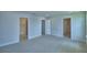 Neutral bedroom with carpet, white doors, and access to the bathroom and walk-in closet at 1476 Leamington Lane, Winter Haven, FL 33884