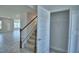 Entryway features a staircase with wood handrail and closet with a white door and wire shelving at 1476 Leamington Lane, Winter Haven, FL 33884