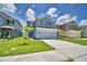 Two-story home featuring well-manicured lawns and complementary landscaping at 1476 Leamington Lane, Winter Haven, FL 33884