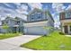 A two-story home features a well-maintained lawn and a spacious driveway at 1476 Leamington Lane, Winter Haven, FL 33884