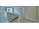 Bright hallway features plush carpet, white trim, and natural light at 1476 Leamington Lane, Winter Haven, FL 33884