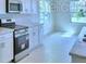Kitchen with white cabinets, stainless steel oven, and breakfast bar at 1476 Leamington Lane, Winter Haven, FL 33884