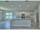 Modern kitchen with white cabinets, granite countertops, and stainless steel appliances offers style and functionality at 1476 Leamington Lane, Winter Haven, FL 33884