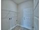 Functional laundry room with a storage shelf and access door at 1476 Leamington Lane, Winter Haven, FL 33884