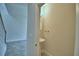 Cozy powder room features neutral paint, a pedestal sink, modern lighting and tile flooring at 1476 Leamington Lane, Winter Haven, FL 33884