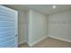 Spacious walk-in closet features carpet flooring, wire shelving, and ample space for storage at 1476 Leamington Lane, Winter Haven, FL 33884