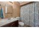 Cozy bathroom featuring a white vanity, tile walls, and a shower with a decorative curtain at 2014 Bardmoor, Winter Haven, FL 33884