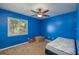 Inviting blue bedroom with ceiling fan, window, and comfortable sleeping area at 2014 Bardmoor, Winter Haven, FL 33884