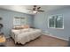 Cozy bedroom features a ceiling fan, a comfortable bed, and natural light at 2014 Bardmoor, Winter Haven, FL 33884