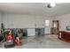 Cluttered garage featuring a white block wall and two exterior doors; lots of room for storage at 2014 Bardmoor, Winter Haven, FL 33884
