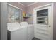 Practical laundry area equipped with a washer, dryer, and access door at 2014 Bardmoor, Winter Haven, FL 33884