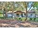 Charming home with a cozy front porch, complemented by well-maintained landscaping and mature trees at 3365 Bahama Ct, Lake Wales, FL 33898