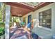 Charming front porch featuring cozy seating, a ceiling fan, and a welcoming blue front door at 3365 Bahama Ct, Lake Wales, FL 33898