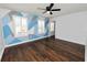 Bedroom with geometric wall design and dark hardwood floors at 3537 Julius Estates Blvd, Winter Haven, FL 33881