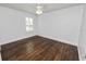 Well-lit bedroom with hardwood floors and window shutters at 3537 Julius Estates Blvd, Winter Haven, FL 33881