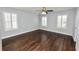 Light-filled bedroom with hardwood floors and window shutters at 3537 Julius Estates Blvd, Winter Haven, FL 33881