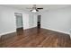 Large bedroom with dark hardwood floors and access to closets at 3537 Julius Estates Blvd, Winter Haven, FL 33881