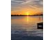 Stunning sunset over the lake with a small dock in the foreground at 3537 Julius Estates Blvd, Winter Haven, FL 33881