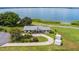 Lakefront property aerial view, single story home with circular driveway at 405 W 4Th Ct, Frostproof, FL 33843