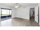 Bedroom with wood-look floors, sliding door to patio and lake view at 405 W 4Th Ct, Frostproof, FL 33843