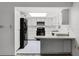 Simple kitchen with white cabinets and black appliances at 405 W 4Th Ct, Frostproof, FL 33843