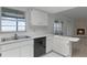 Kitchen with white cabinets, double sink, and a fireplace in the adjacent room at 405 W 4Th Ct, Frostproof, FL 33843