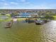 Aerial view of waterfront community clubhouse, pool, and docks on the lake with walking path to building at 4104 Martindale Loop, Winter Haven, FL 33884