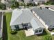 Aerial view of home featuring a patio, outdoor seating, mature landscaping and adjacent residences at 4104 Martindale Loop, Winter Haven, FL 33884