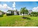 Backyard featuring a well-manicured lawn, mature landscaping, and a rear exterior home view at 4104 Martindale Loop, Winter Haven, FL 33884