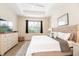 Relaxing bedroom featuring a large bed, a white dresser, a ceiling fan, and a light-filled window at 4104 Martindale Loop, Winter Haven, FL 33884