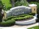 Elegant stone community sign with decorative landscaping and manicured shrubbery at 4104 Martindale Loop, Winter Haven, FL 33884