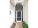 Screened entryway with brick walkway and landscaping at 4104 Martindale Loop, Winter Haven, FL 33884