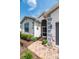 House entryway with brick walkway and landscaping at 4104 Martindale Loop, Winter Haven, FL 33884