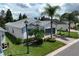 Exterior view of a well-kept home, featuring a two-car garage, lush lawn, and manicured landscaping at 4104 Martindale Loop, Winter Haven, FL 33884