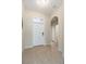 Inviting foyer with a white front door, tile flooring, an arched doorway, and neutral wall paint at 4104 Martindale Loop, Winter Haven, FL 33884