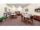 Well-lit game room featuring tables with board games, comfortable seating, and a bookshelf filled with board games at 4104 Martindale Loop, Winter Haven, FL 33884