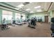 Spacious gym featuring various exercise machines including treadmills, ellipticals, and weightlifting equipment for a complete workout at 4104 Martindale Loop, Winter Haven, FL 33884