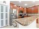 Modern kitchen island with granite countertops and stainless steel appliances at 4104 Martindale Loop, Winter Haven, FL 33884