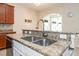 Kitchen island with granite countertops and double sink at 4104 Martindale Loop, Winter Haven, FL 33884