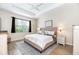 Main bedroom with a king-size bed and wood flooring at 4104 Martindale Loop, Winter Haven, FL 33884