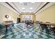 Large meeting room with checkered flooring, tables, chairs, and a wall clock under bright ceiling lights at 4104 Martindale Loop, Winter Haven, FL 33884