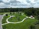 Beautiful aerial view of a community park with walking paths, picnic tables, green space, and a gazebo at 4104 Martindale Loop, Winter Haven, FL 33884