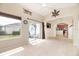 Sunroom with view into kitchen, tile floors, and sliding glass doors at 4104 Martindale Loop, Winter Haven, FL 33884