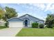 Blue house with white garage door and manicured lawn at 752 Hunt Dr, Lake Wales, FL 33853