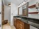 Bathroom vanity with dark granite countertop and traditional fixtures that offers functionality at 3808 Gaines Dr, Winter Haven, FL 33884