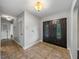 Entryway featuring tiled flooring, front door, and multiple light fixtures at 3808 Gaines Dr, Winter Haven, FL 33884