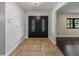 View of the entryway showcasing a beautiful double door and tiled flooring at 3808 Gaines Dr, Winter Haven, FL 33884